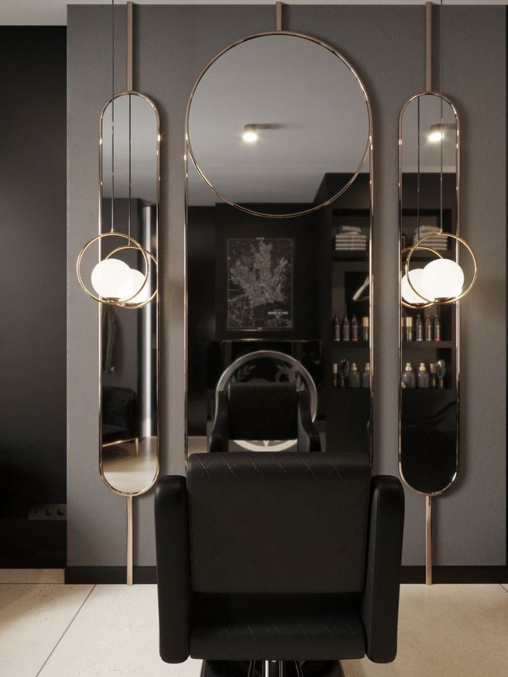 Black quilted styling chair with brass-framed mirror